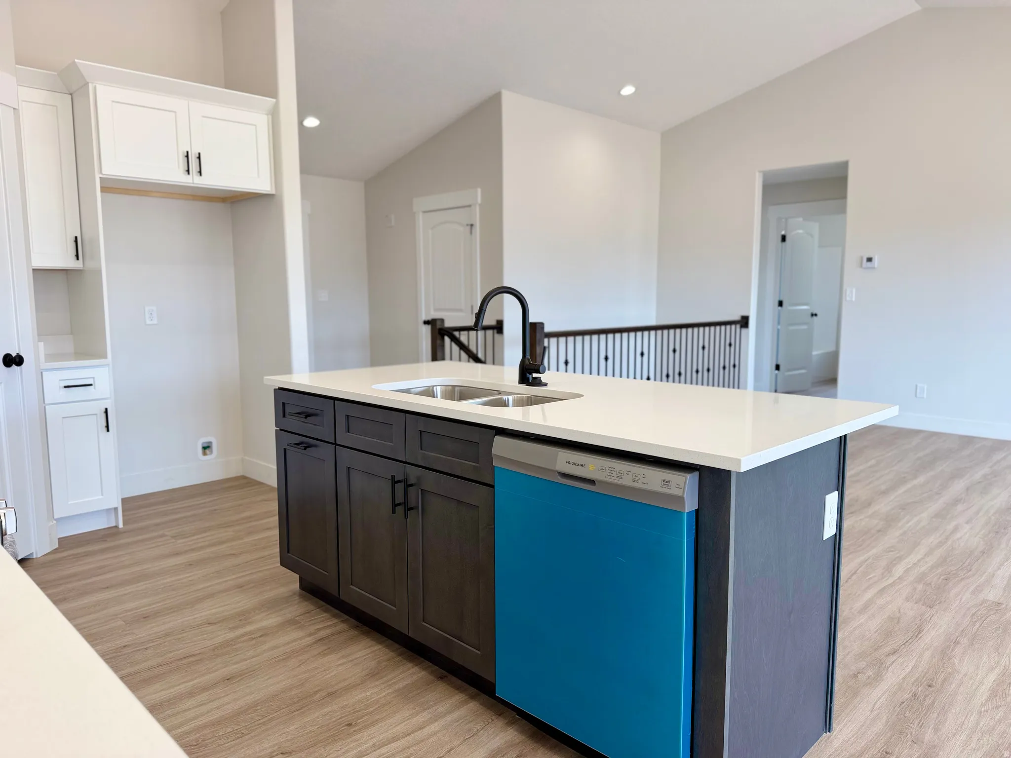 Kitchen with two-tone custom cabinetry with soft-close. Center island sink and dishwasher