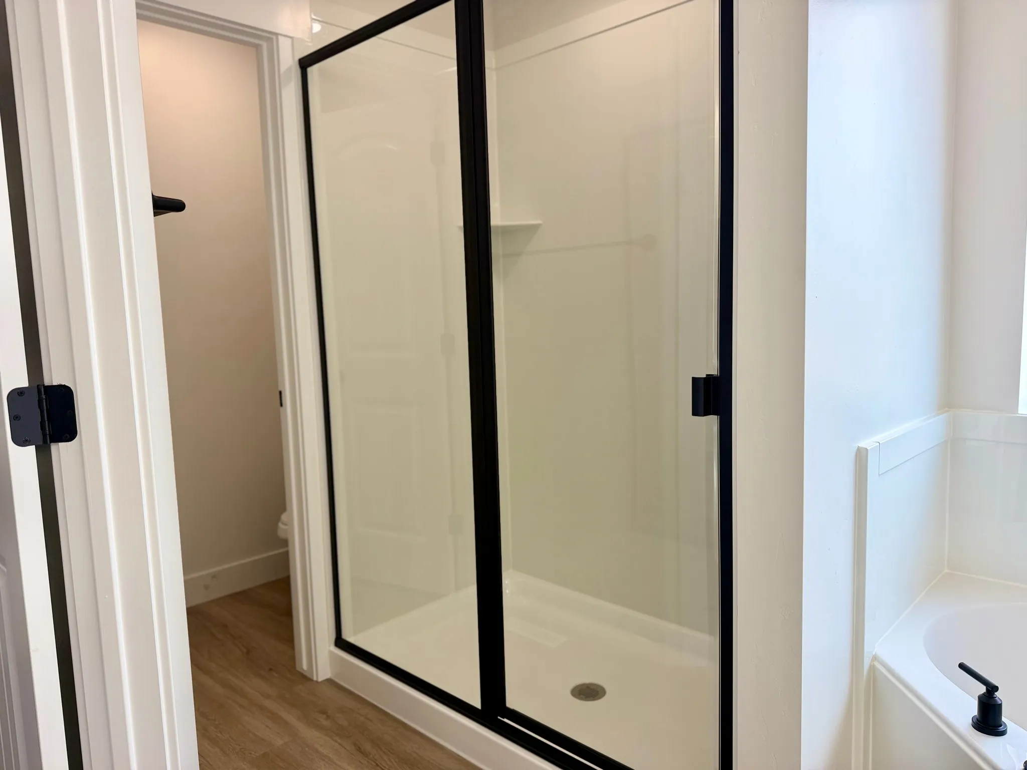 Primary ensuite bathroom with dual vanities, oversized corner tub and separate shower