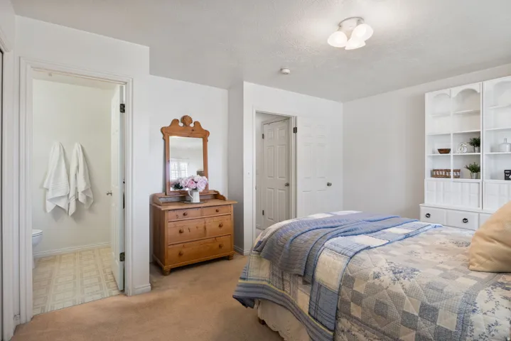 Primary Bedroom featuring carpet flooring, white walls, and a ceiling-mounted light fixture