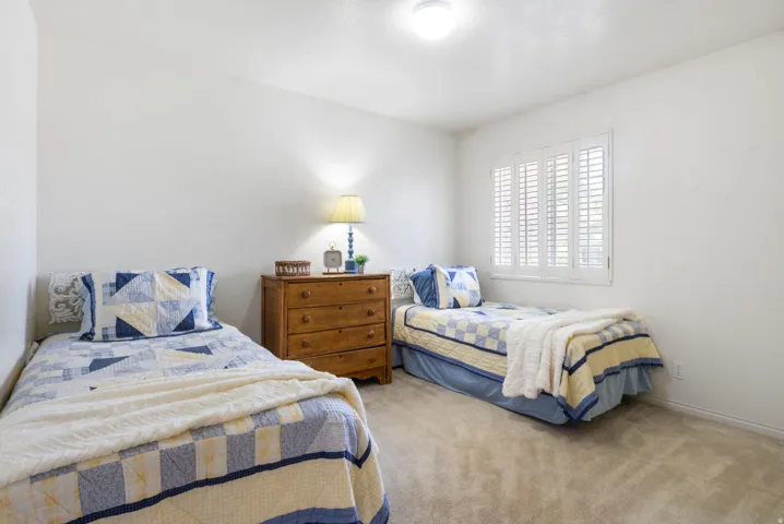 Bright room featuring neutral wall paint and light-colored carpeting