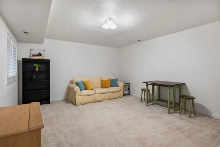 Spacious bedroom with plush carpeting and neutral wall tones