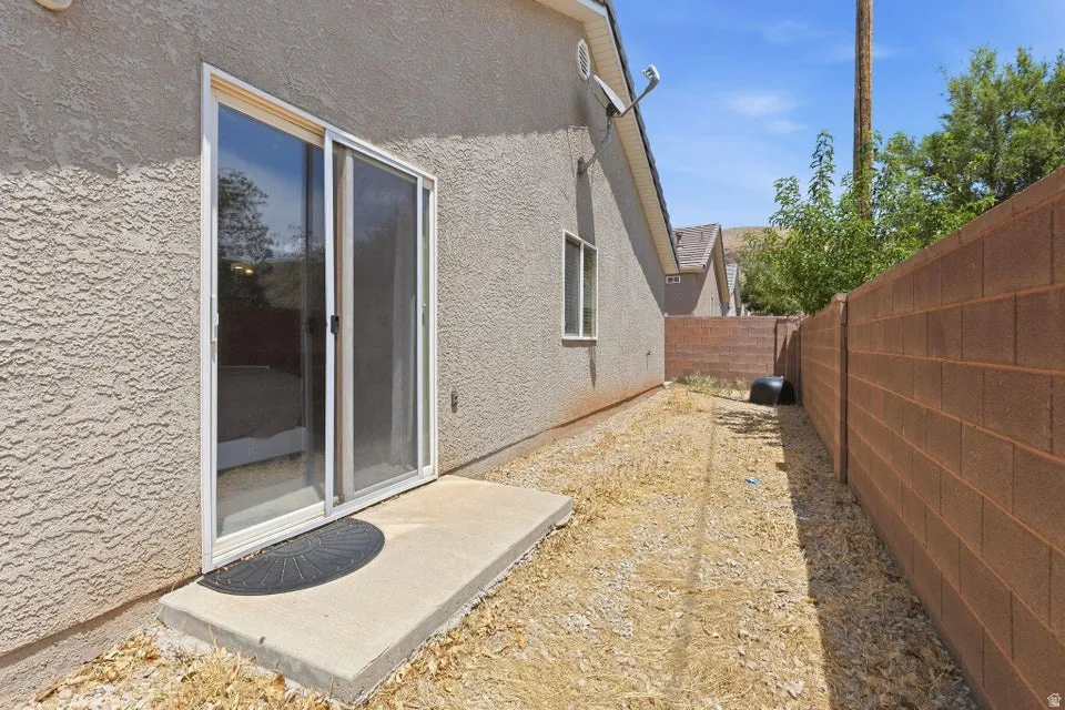 Sliding glass door opening onto a concrete patio