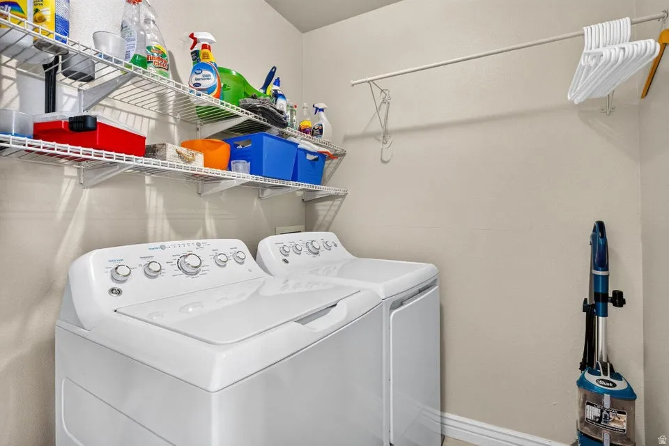 Dedicated utility space featuring a neutral wall color, wire shelving, and a wall-mounted hanging rod