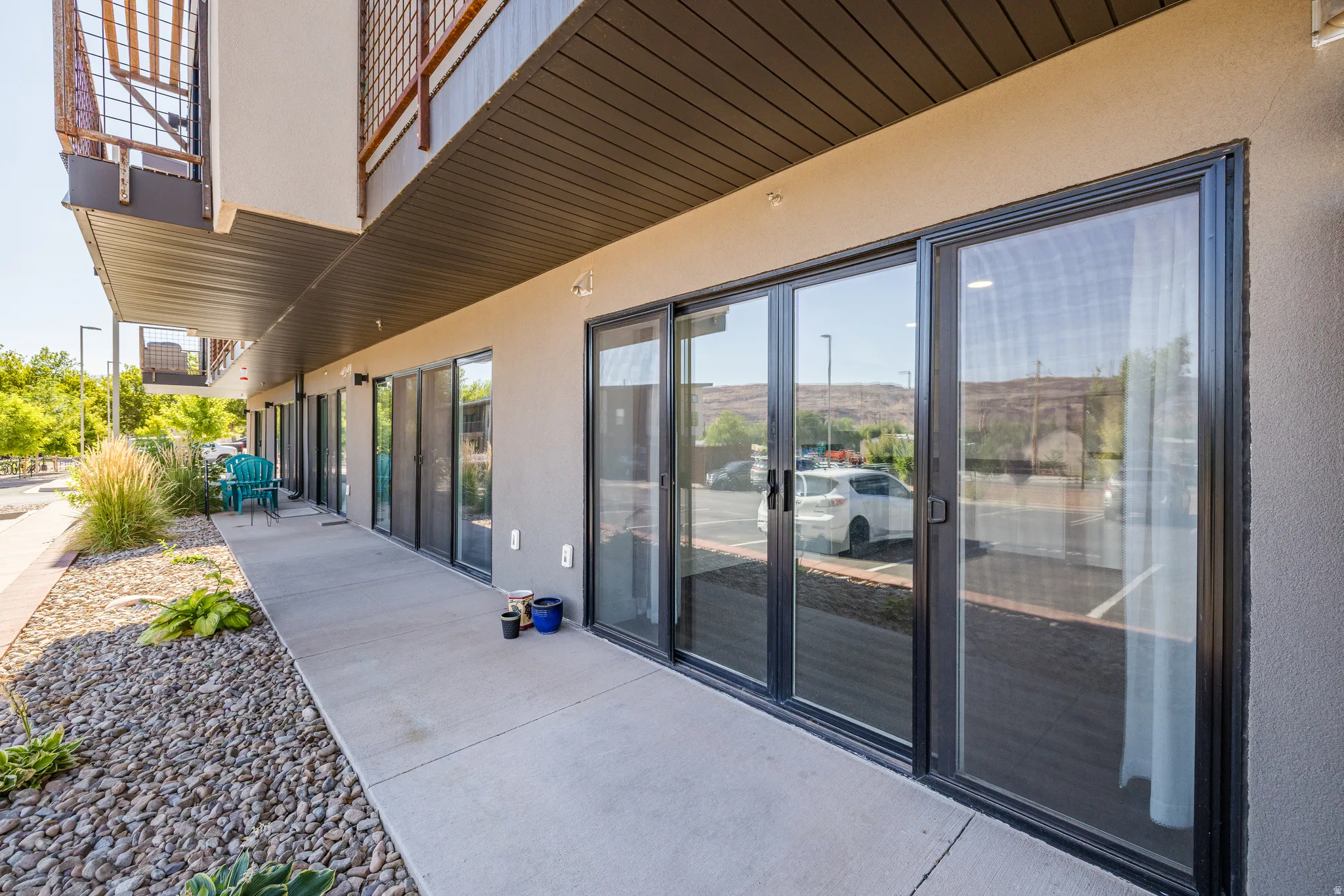 Ground-level patio with polished concrete flooring and multiple sliding glass doors