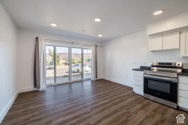 Open concept living area featuring wood-finish flooring, recessed lighting, and a full-light sliding glass door