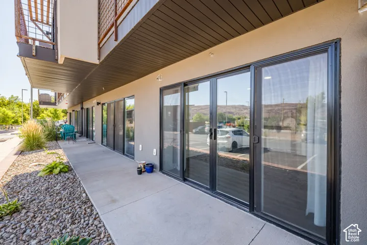 Ground-level patio with polished concrete flooring and multiple sliding glass doors