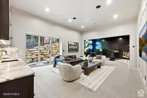 Recessed lighting illuminates the open-concept living space with light-toned flooring