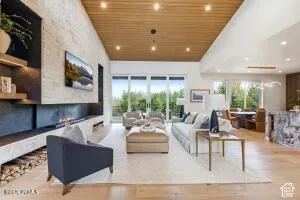 Open-concept living area with wood-finish flooring, a wood-paneled ceiling, and recessed lighting