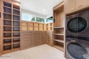 Built-in storage cabinetry with extensive shelving, multiple drawers, and integrated laundry appliances