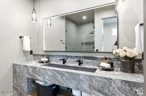 Floating vanity with a stone countertop and integrated rectangular sink