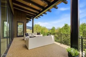Expansive outdoor terrace with a wood plank ceiling and exposed beams