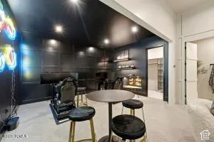 Accent wall with paneling, built-in shelving, recessed lighting, and light-colored flooring