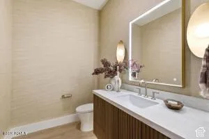 Floating vanity with a fluted wood finish, integrated sink, and brushed nickel faucet