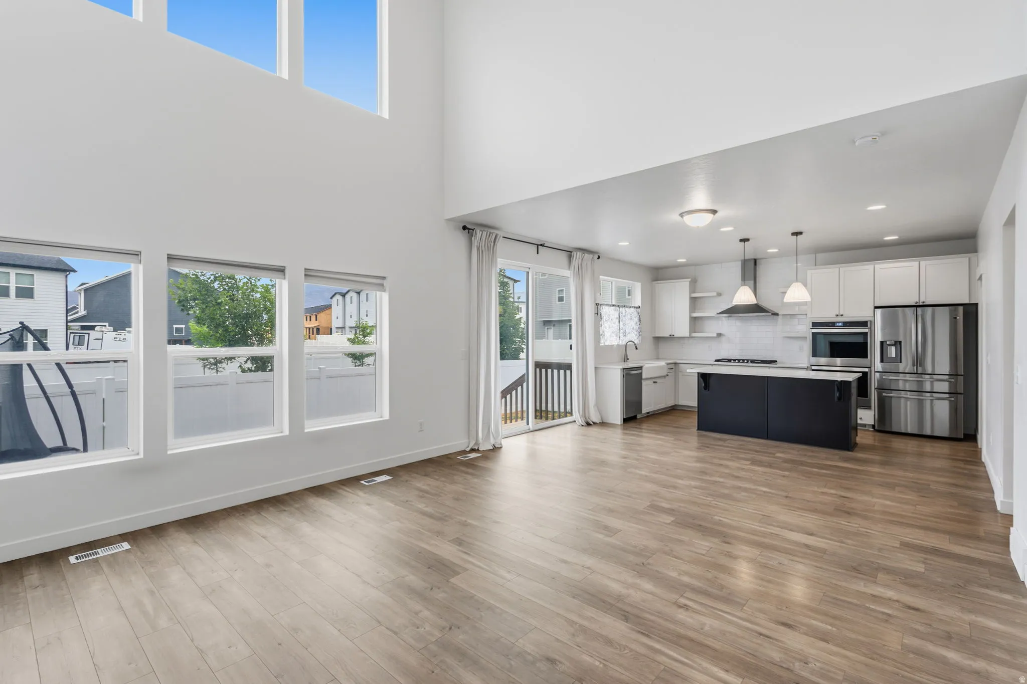 Spacious open-concept interior featuring wood-finish flooring throughout