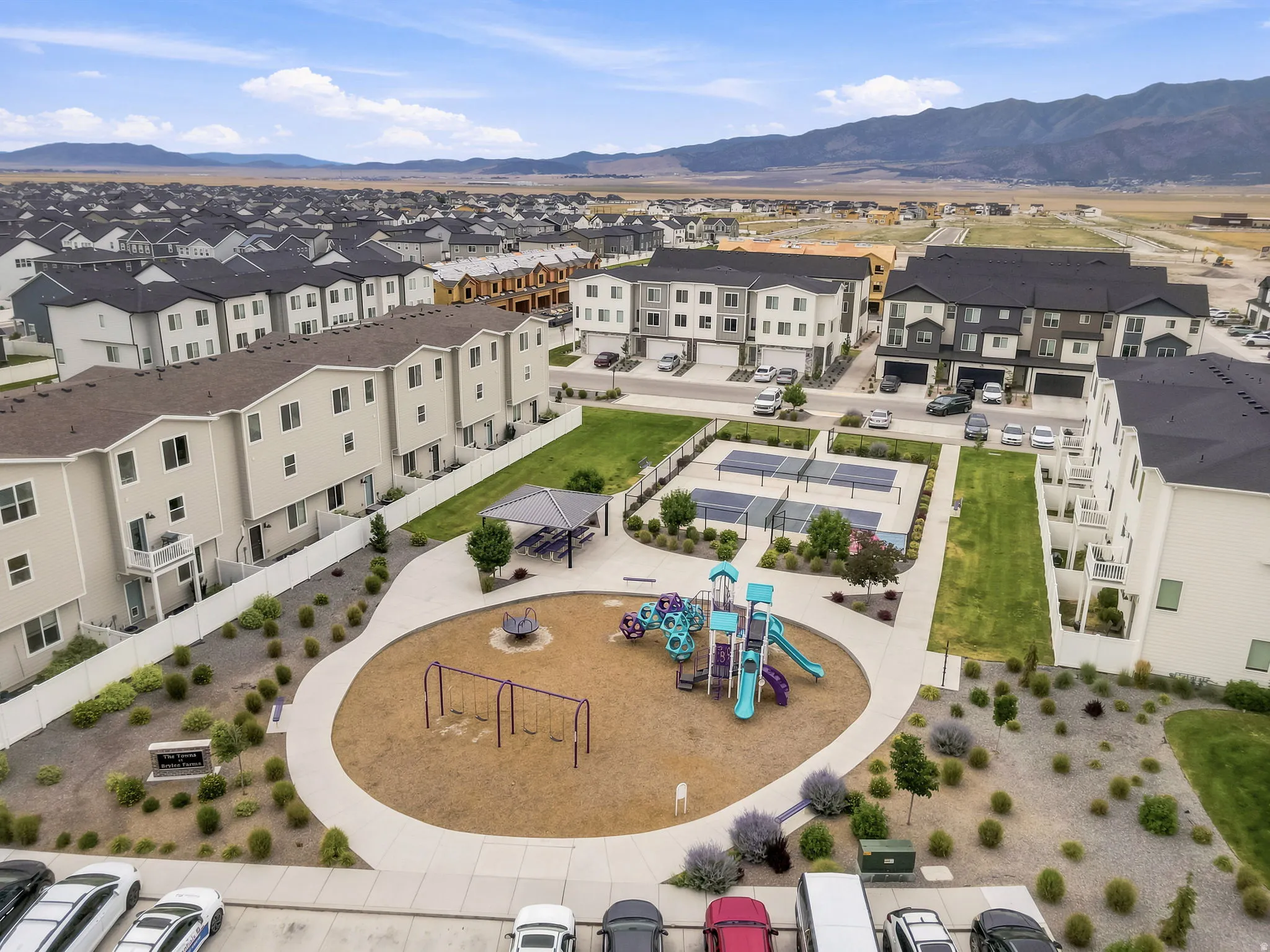 Community park featuring a playground, swing set, and covered picnic area
