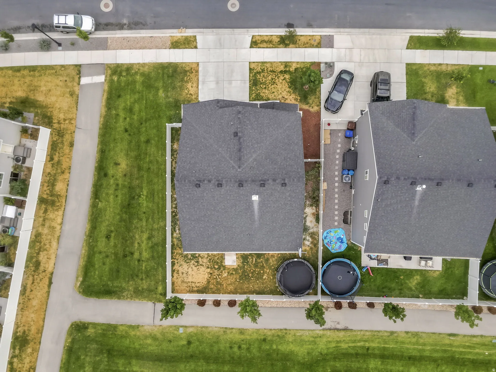 Aerial perspective showcasing a residential property with a dark shingle roof