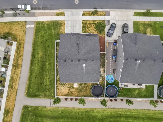 Aerial perspective showcasing a residential property with a dark shingle roof