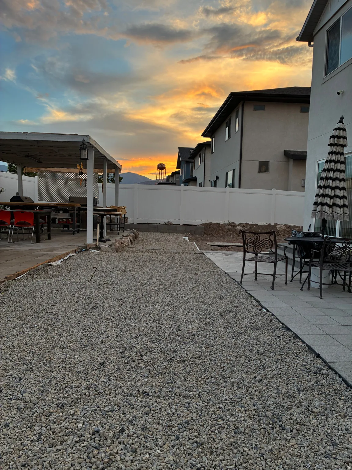 Backyard featuring a covered patio structure with a flat roof, string lighting, and an attached privacy screen