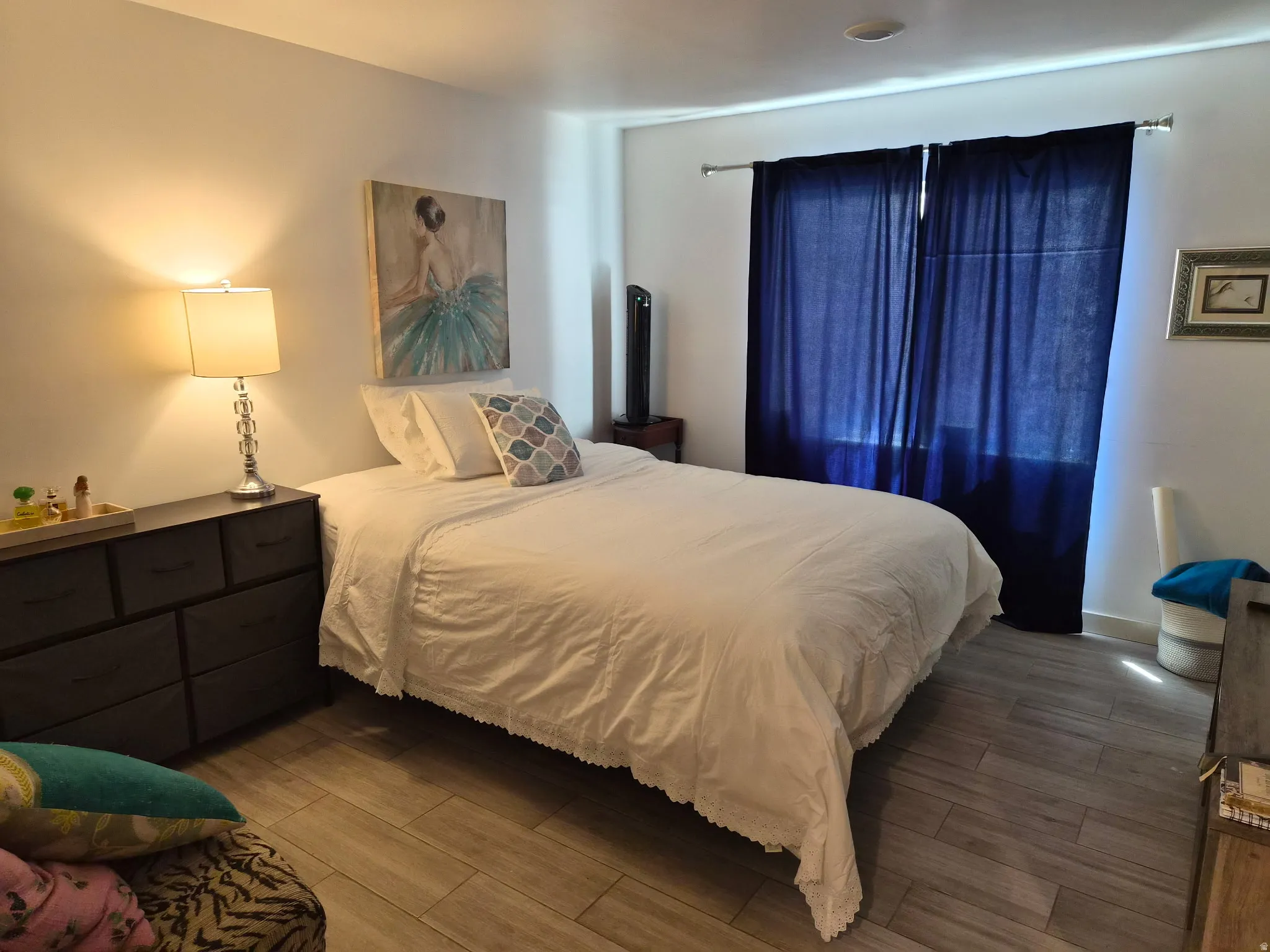 Light wood-finish flooring complements the neutral wall color
