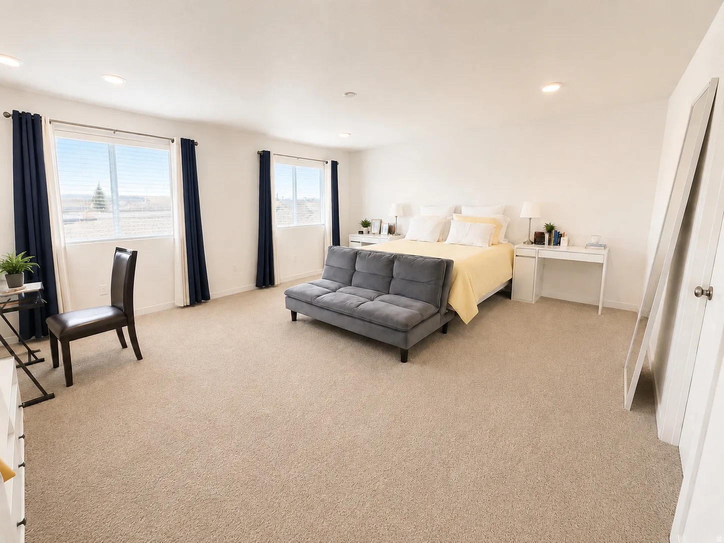 Expansive room featuring carpet flooring, recessed lighting, and multiple windows
