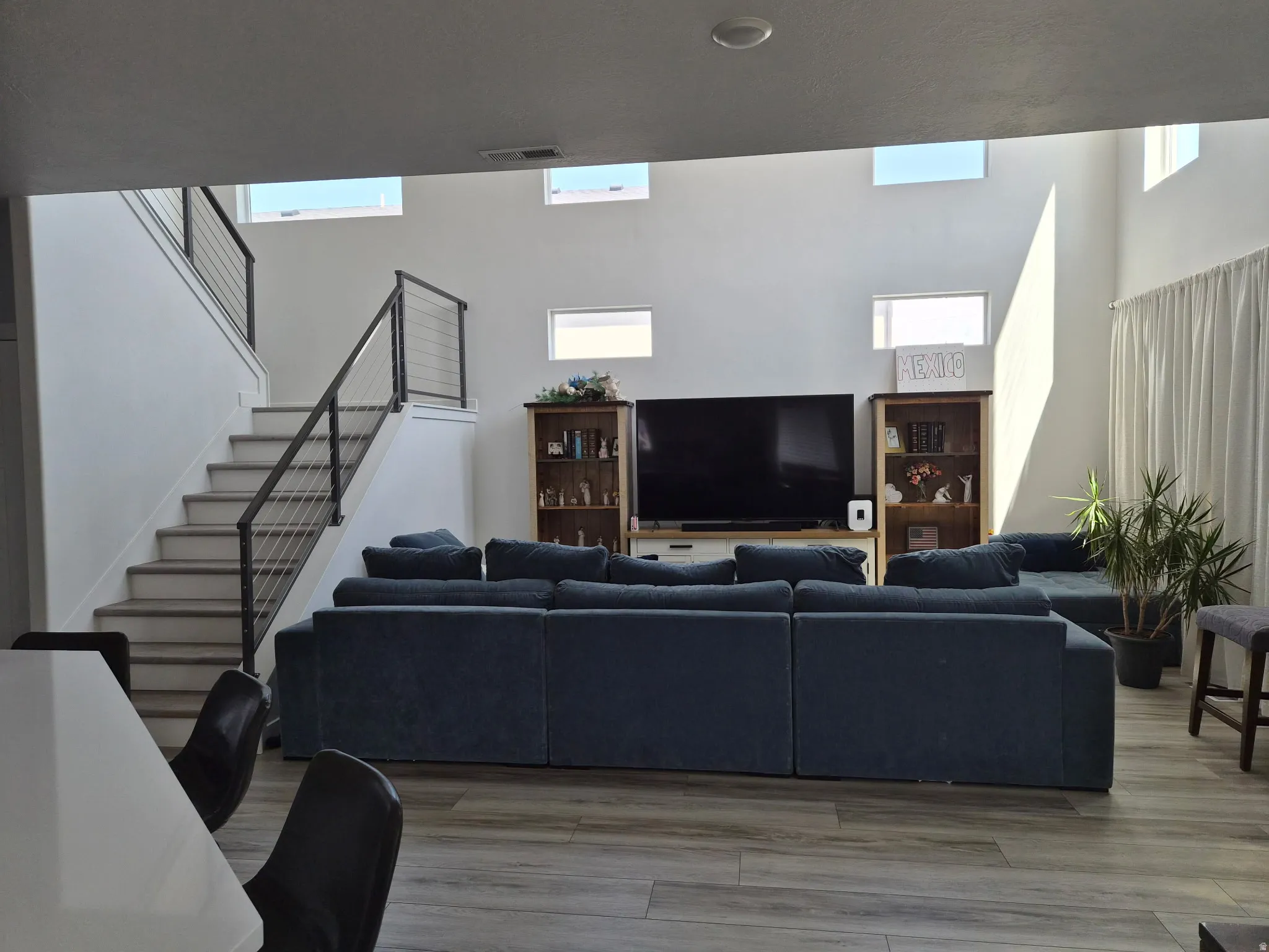 Spacious room with high ceilings and multiple upper windows