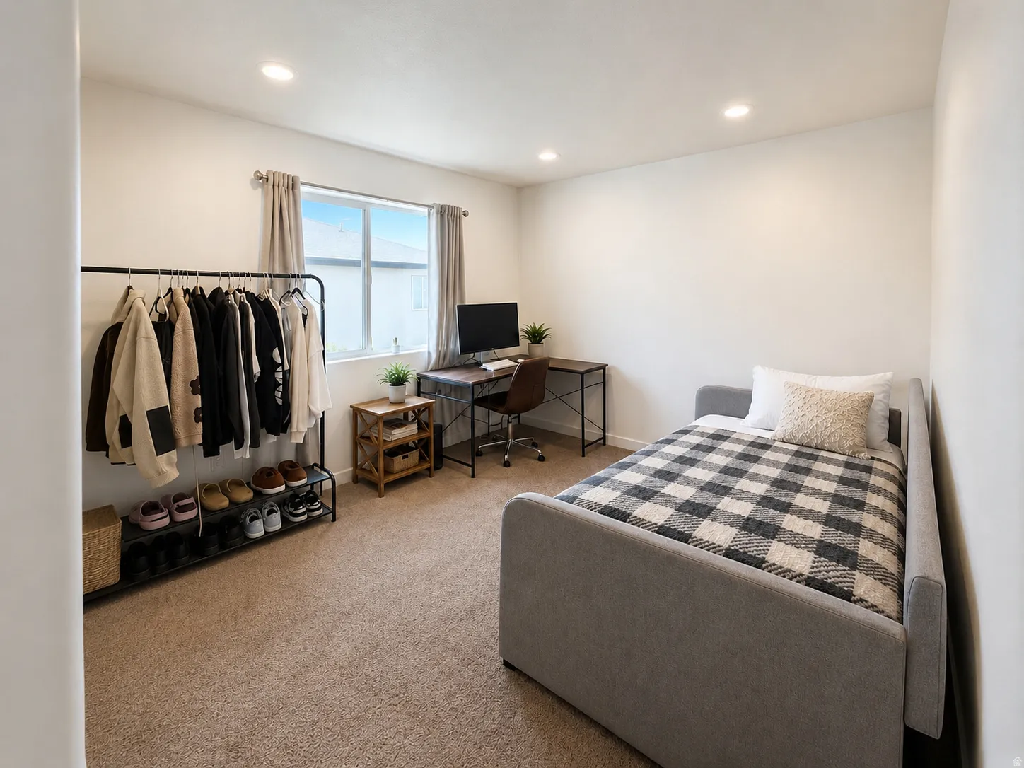 Recessed lighting, light-toned carpeting, white wall finishes, and a window with roller shades