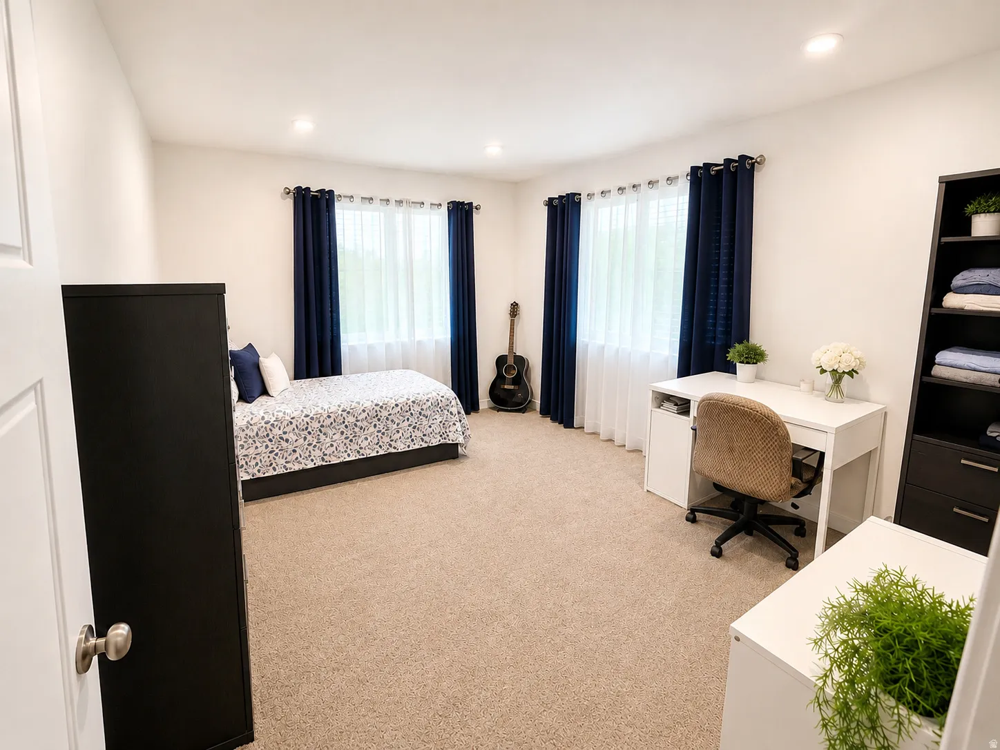 Recessed lighting, light-toned carpeting, and multiple windows