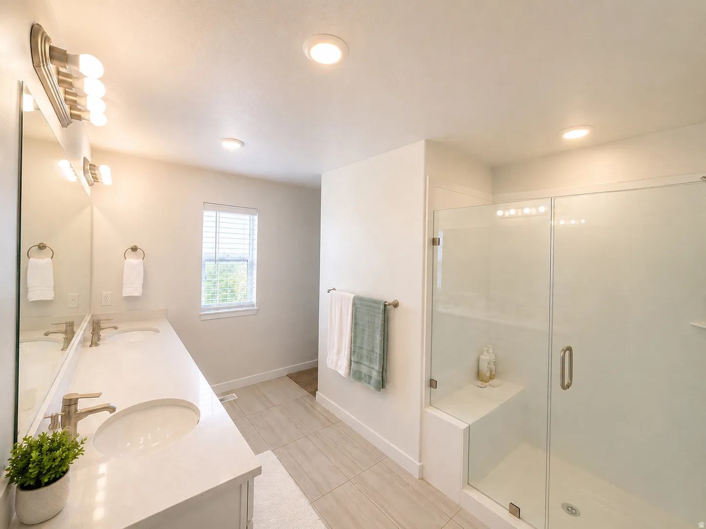 Dual vanity with undermount sinks and brushed nickel faucets
