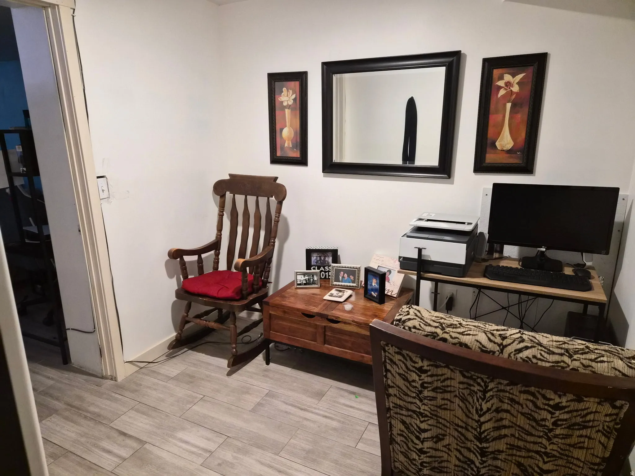 Bright interior space featuring light-toned wood-finish flooring, white walls, and a recessed doorway