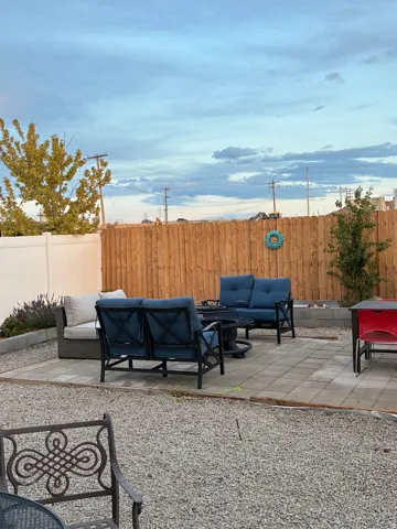 Outdoor paver patio framed by a gravel landscape