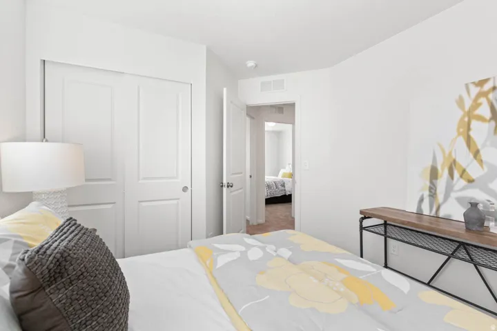 White interior walls with a built-in closet featuring bi-fold doors
