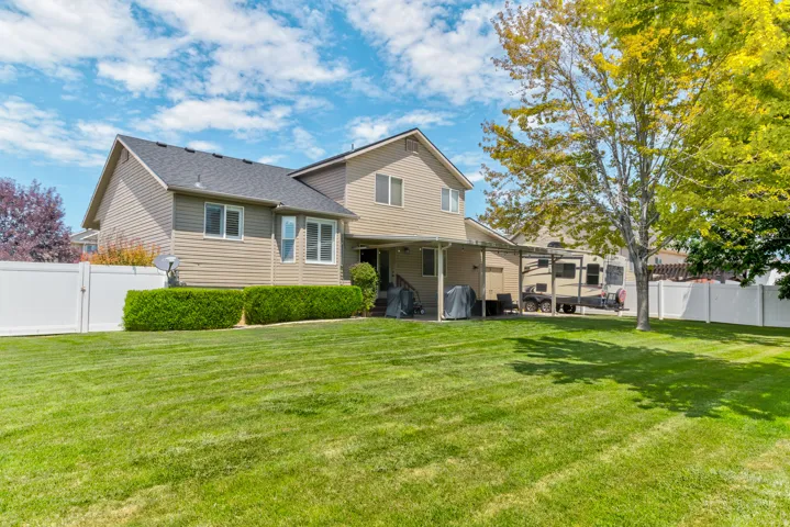 Expansive green lawn with a vinyl privacy fence