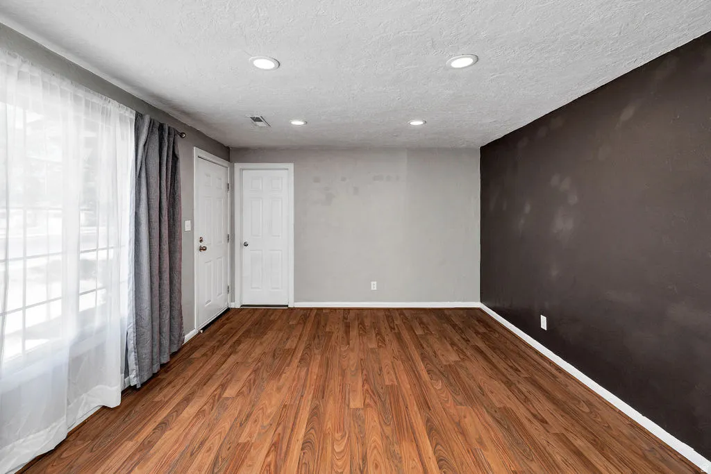 Wood-finish flooring throughout, complemented by recessed lighting