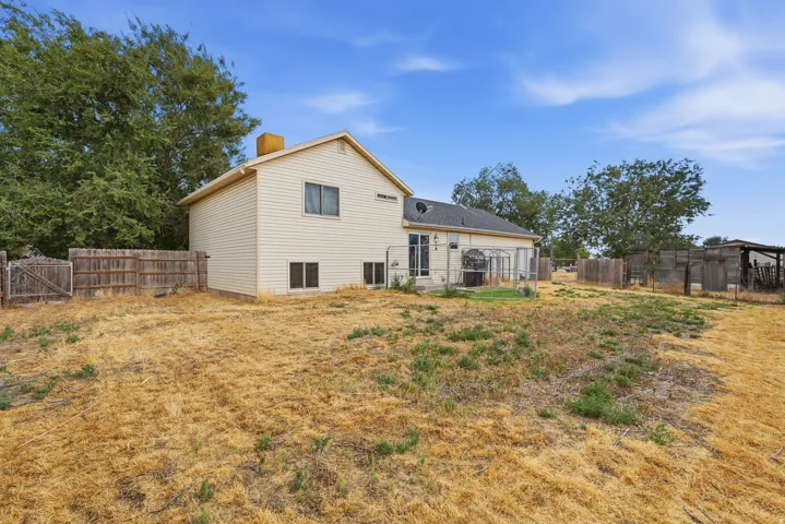 Exterior siding residence featuring a fenced perimeter