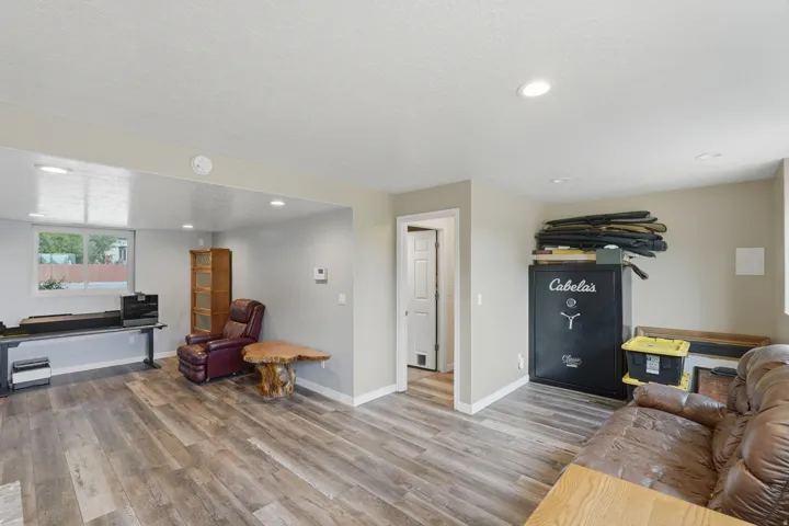 Spacious room featuring wood-finish flooring, recessed lighting, and neutral wall tones