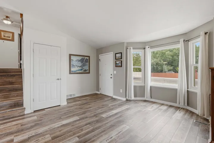 Living area featuring wood-finish flooring and a multi-panel bay window