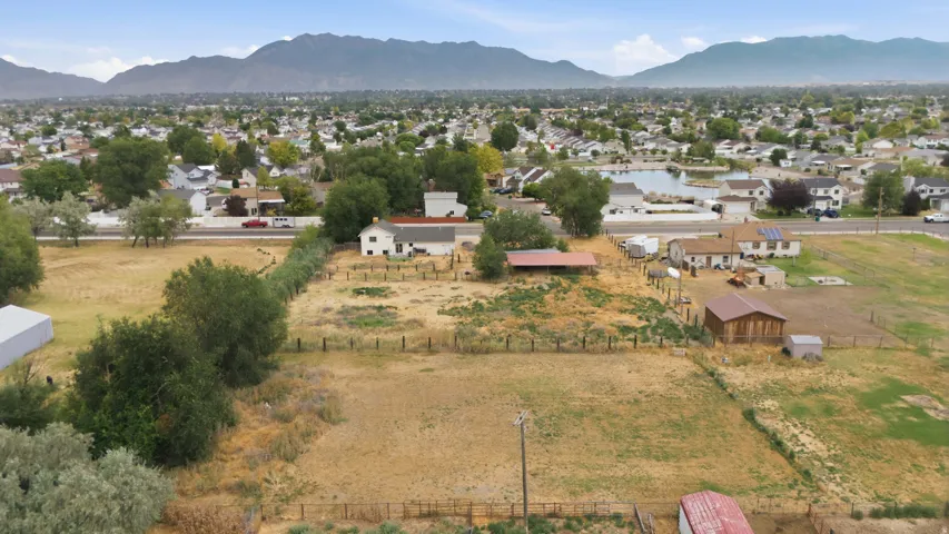 Expansive property featuring multiple outbuildings, fenced areas, and a spacious lot with mature trees