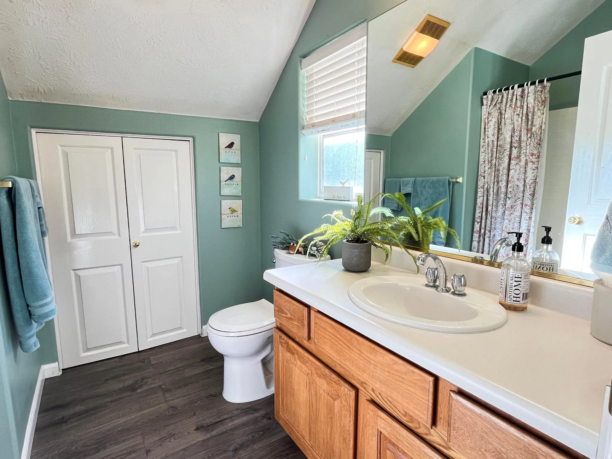 Vanity with an integrated oval sink, chrome faucet, and wood-finish cabinetry