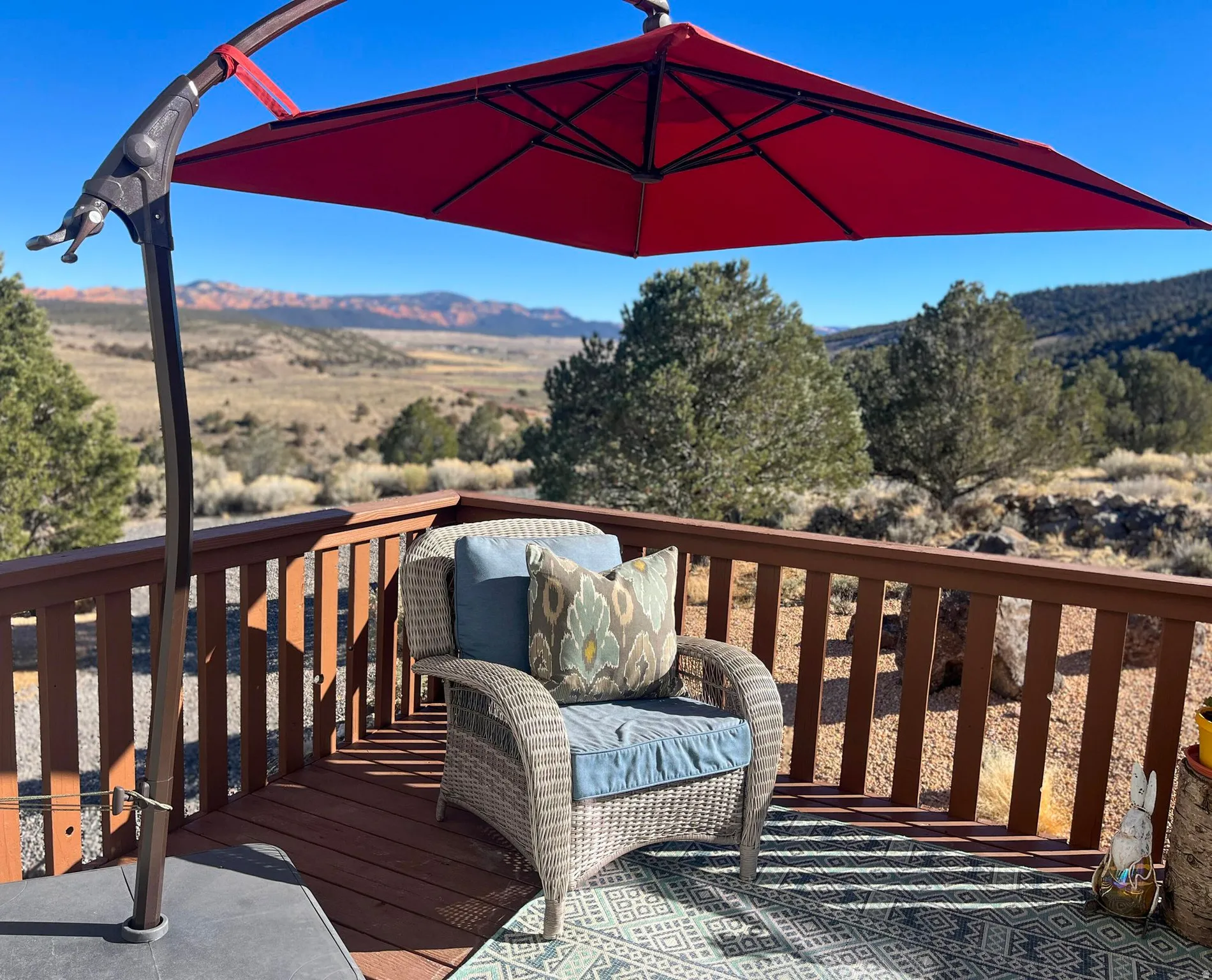 Expansive outdoor deck featuring a rich brown wood-finish railing and decking