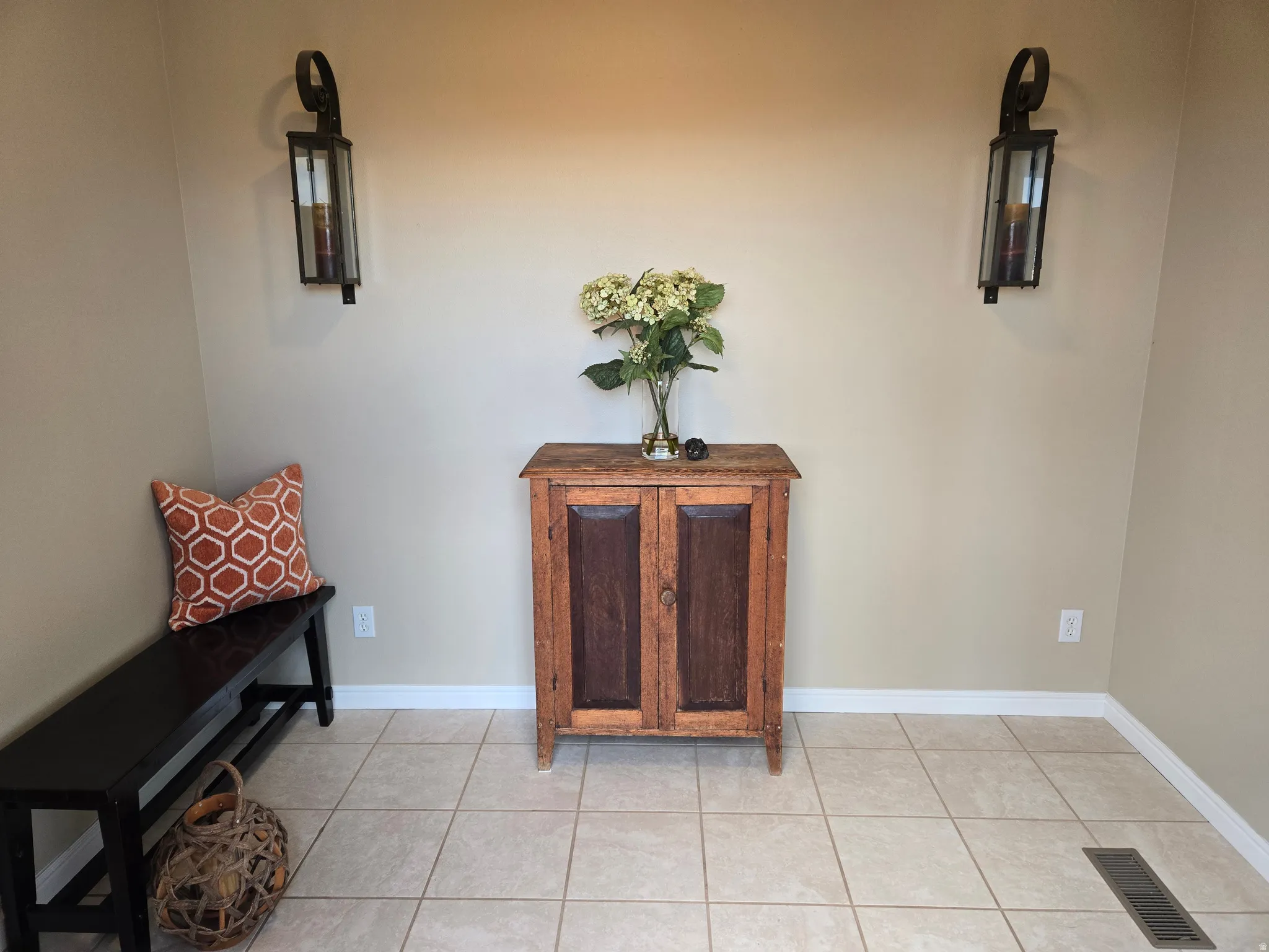 Neutral-toned walls featuring two mounted sconces with glass panels