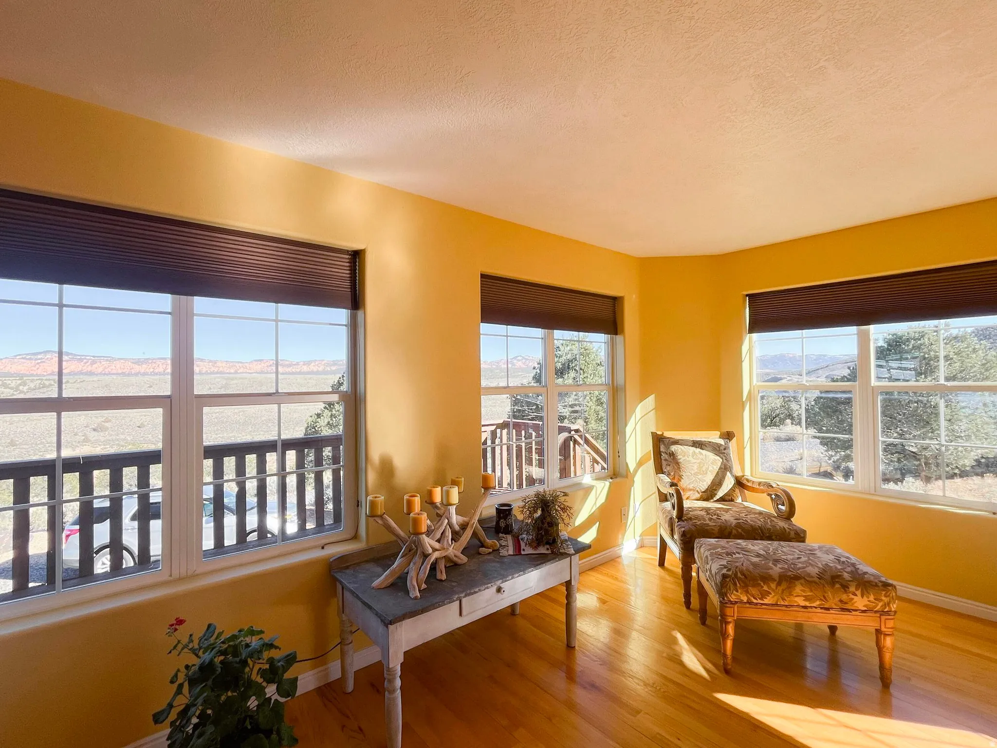 Bay window area featuring multiple large windows with distant mountain scenery