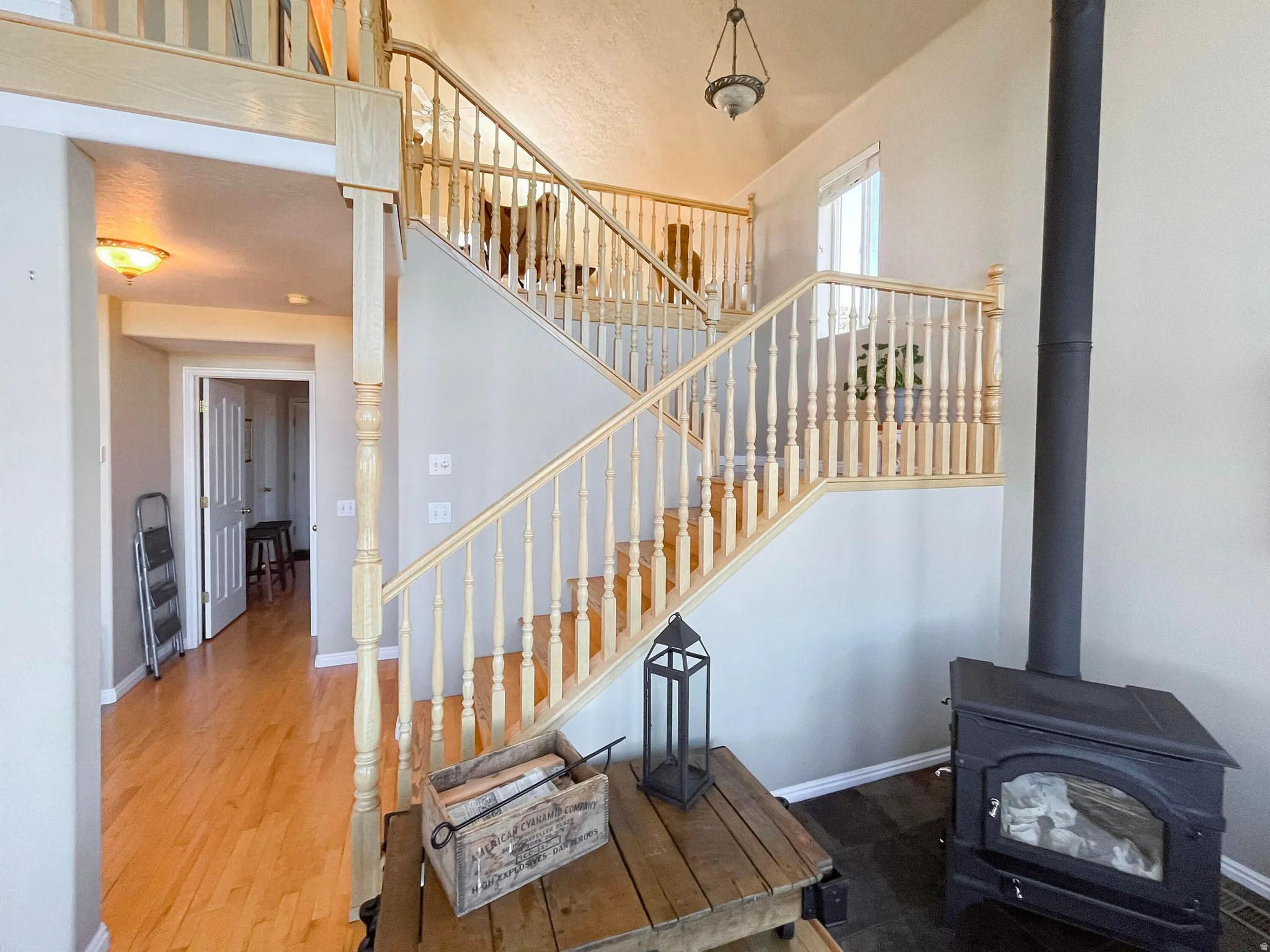 Multi-level staircase with light wood newel posts and spindles