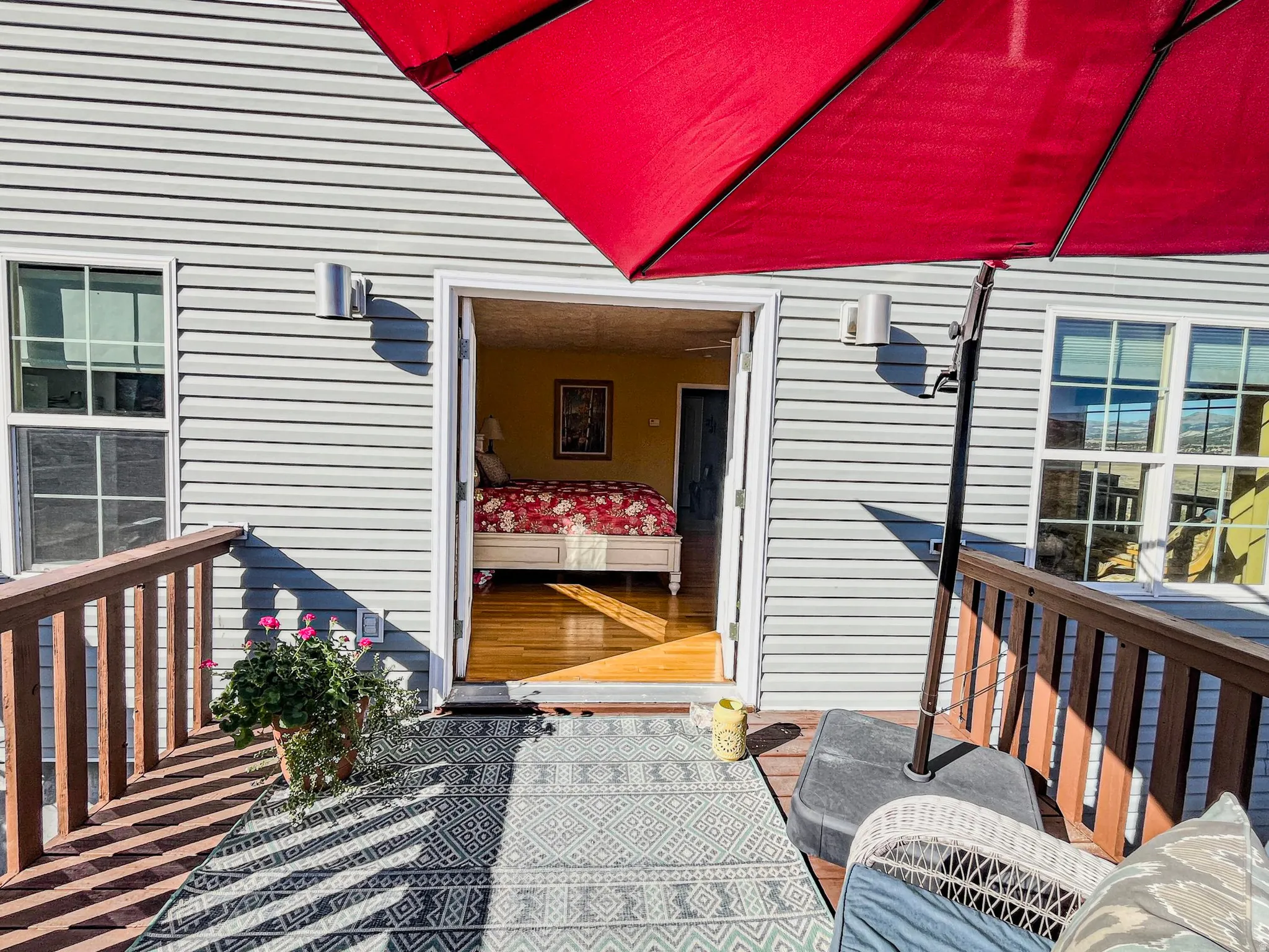 Outdoor deck featuring wood railings and light gray siding