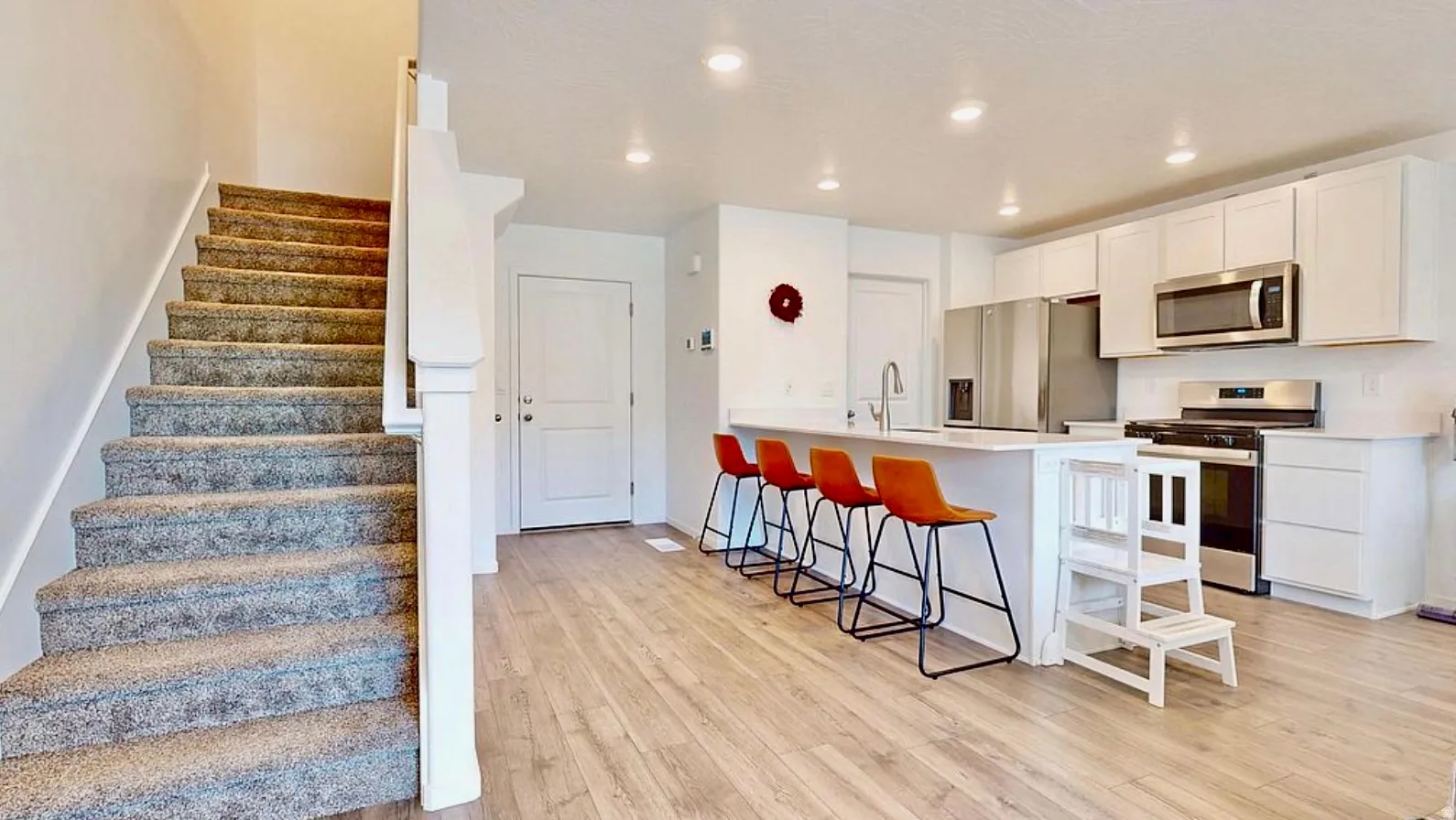 Open-concept main living area featuring wood-finish flooring