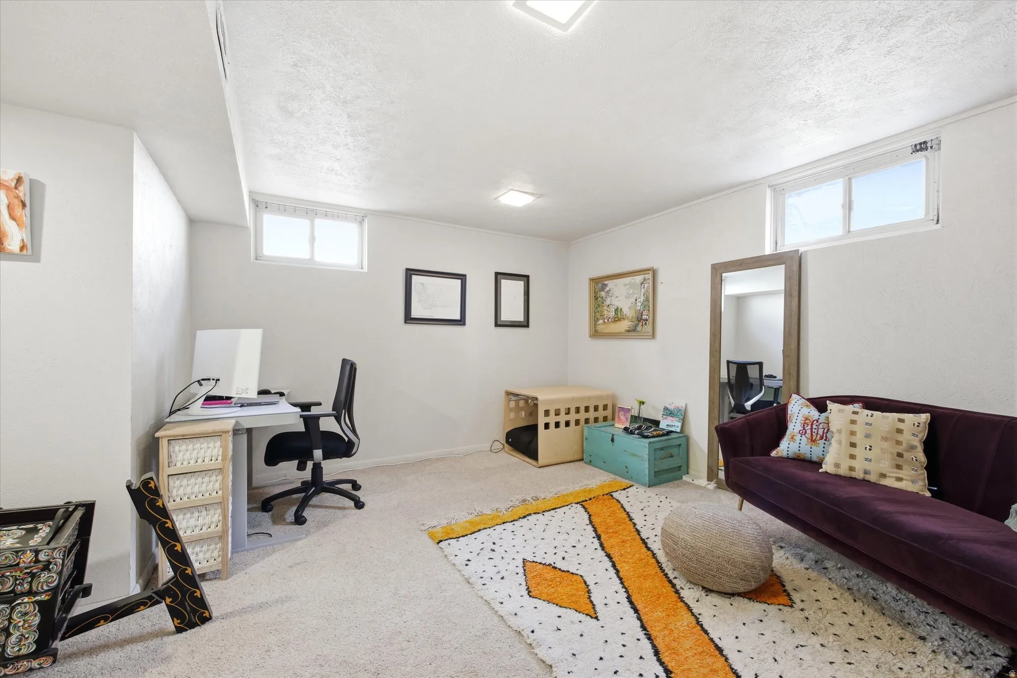 Spacious carpeted room featuring white walls, two transom windows, and recessed lighting