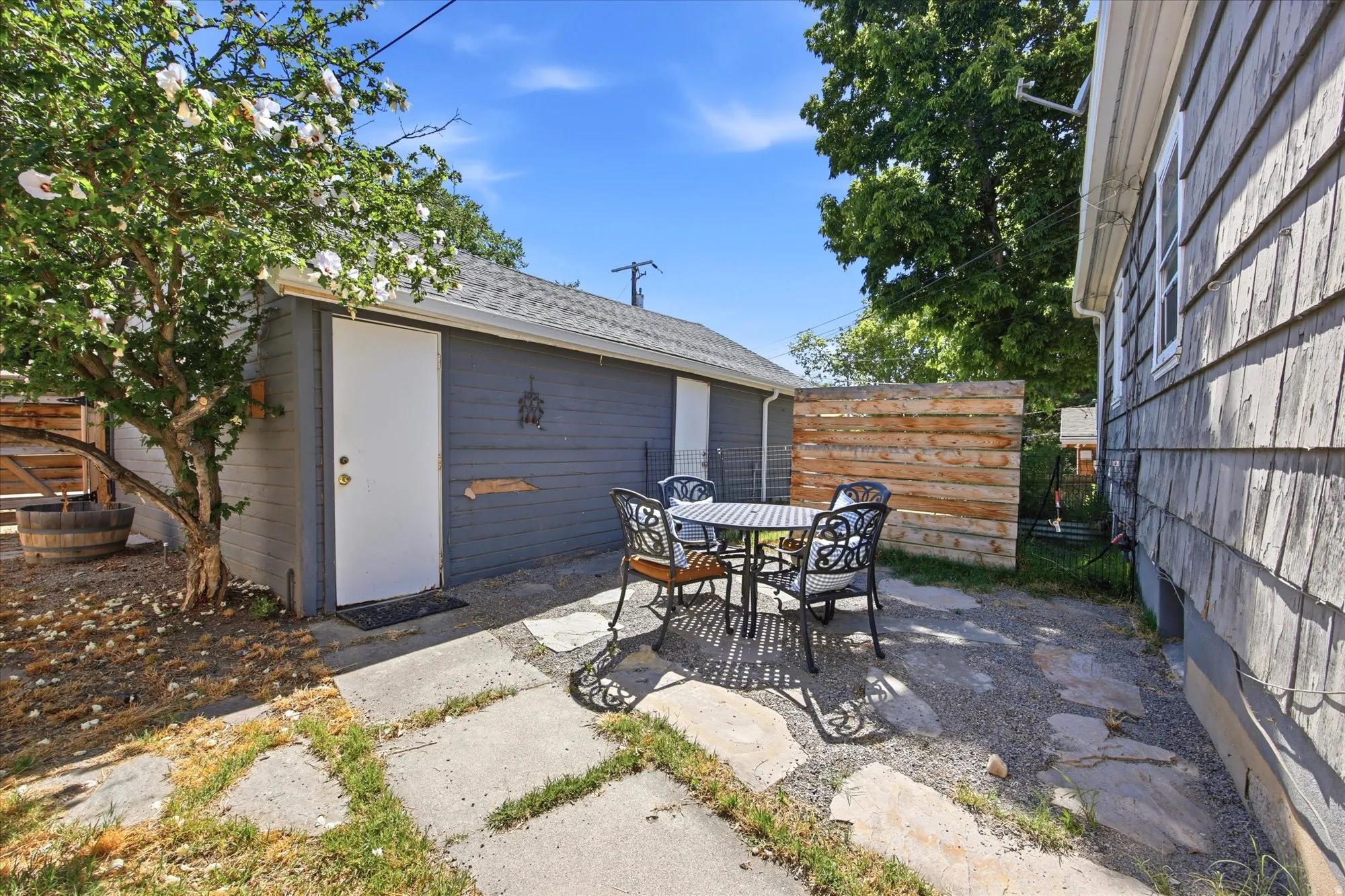 Outdoor patio area featuring flagstone pavers and gravel