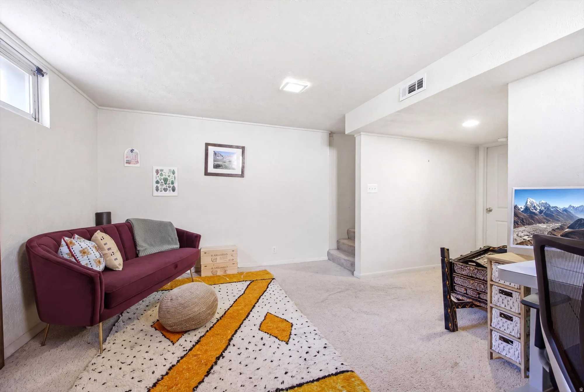 Finished lower level space featuring light-colored carpeting and white walls