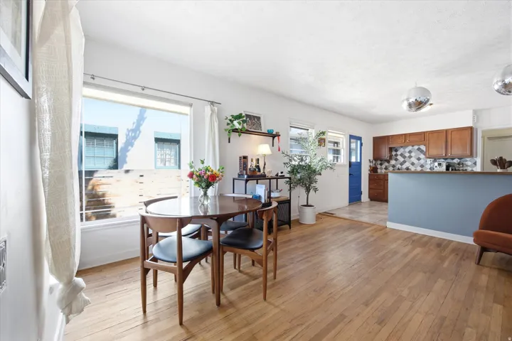 Open concept living area featuring wood-finish flooring