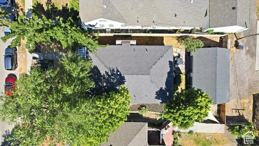 Main property featuring a grey shingle roof, accompanied by a detached structure with a matching grey shingle roof