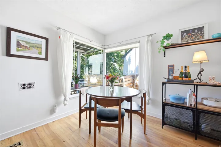 Hardwood flooring throughout, with white baseboards and trim